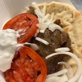 Gyros — Greek pita wrap with tzatziki and tomatoes